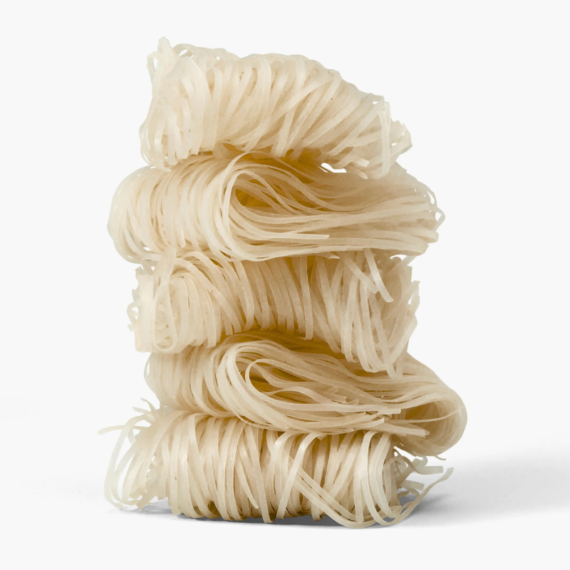 Uncooked noodles on a white background
