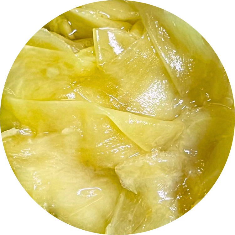 Thinly sliced Viet Haus organic ginger preserved in brine, showing crisp texture and vibrant natural color for culinary condiments and sushi accompaniment.