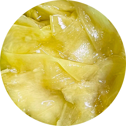 Thinly sliced Viet Haus organic ginger preserved in brine, showing crisp texture and vibrant natural color for culinary condiments and sushi accompaniment.