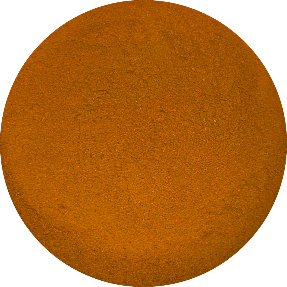 Top view of a circular pile of organic orange-brown spice powder