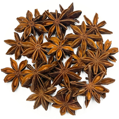 A pile of organic star anise pods on a white background