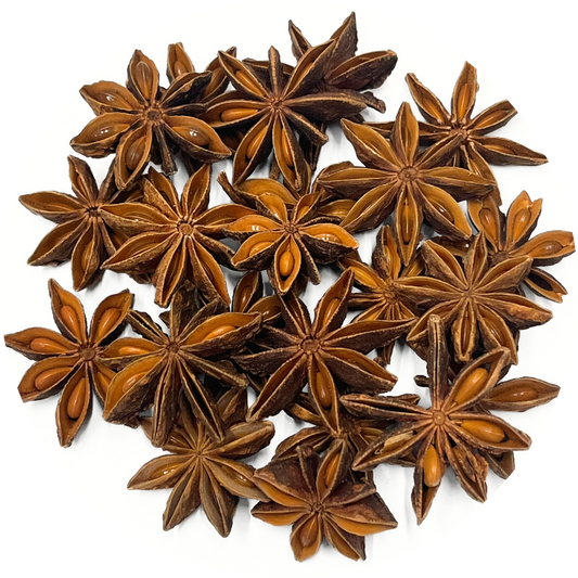 A pile of organic star anise pods on a white background