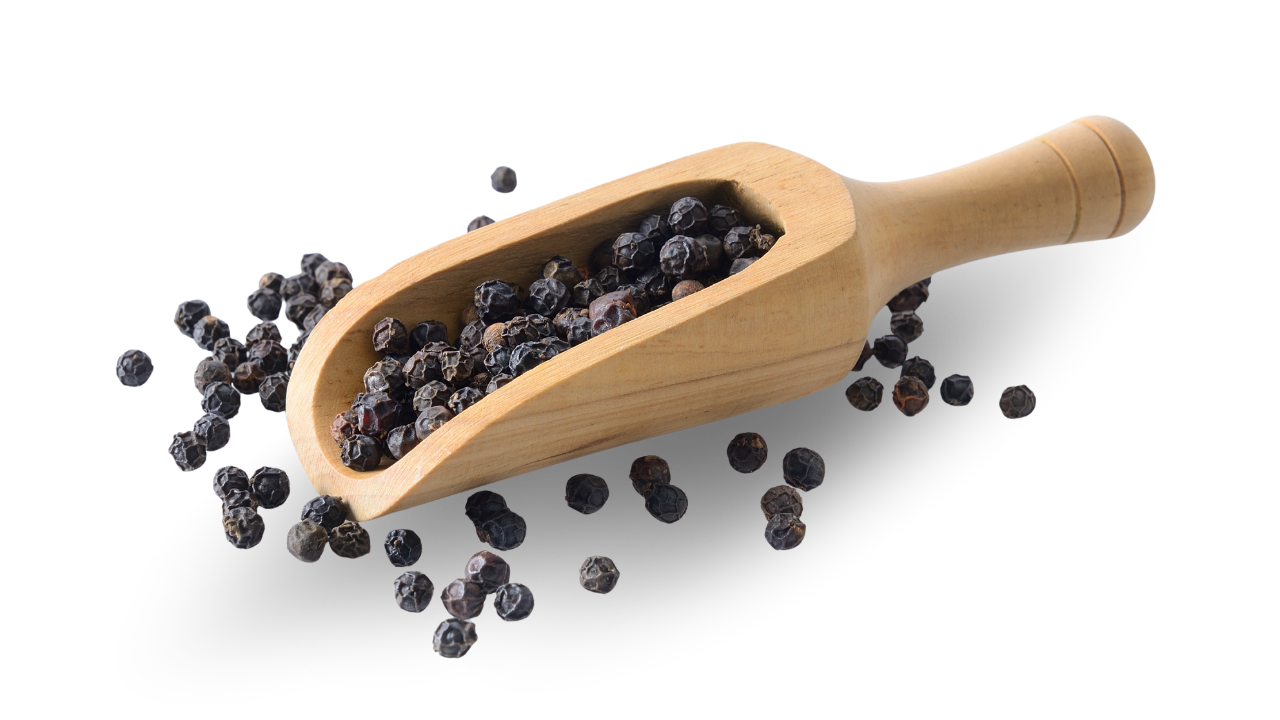 A wooden scoop filled with whole organic black peppercorns, showing the dark wrinkled skin