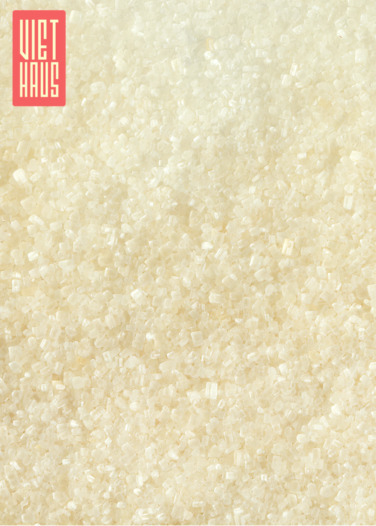 A detailed close-up shot of organic cane sugar crystals, showcasing their natural, light golden color and uniform texture.