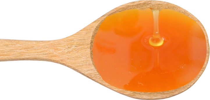 Clear organic coconut flower nectar being poured, showing its natural golden color and liquid texture.