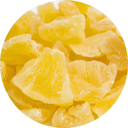 Macro circular view of golden, translucent dried pineapple chunks from Ninh Thuan, Vietnam, showcasing a crystalline texture and rich natural sweetness