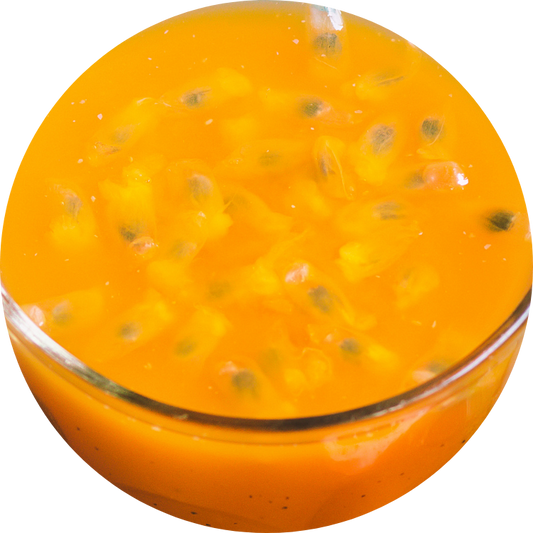 Clear glass of organic passion fruit juice showing its natural bright orange color