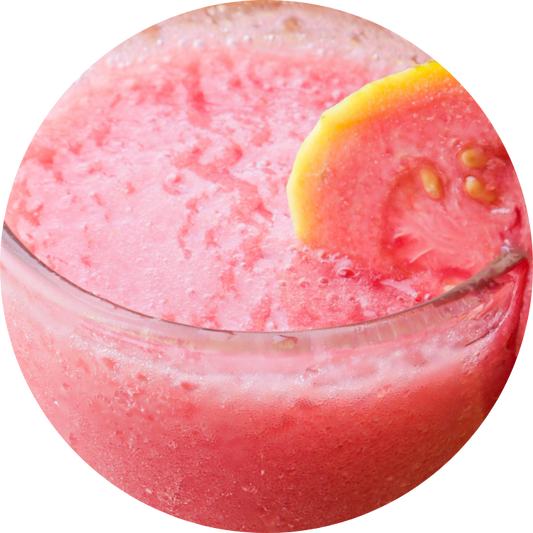 Organic pink guava juice in a glass showing its natural cloudy texture and vibrant pink color