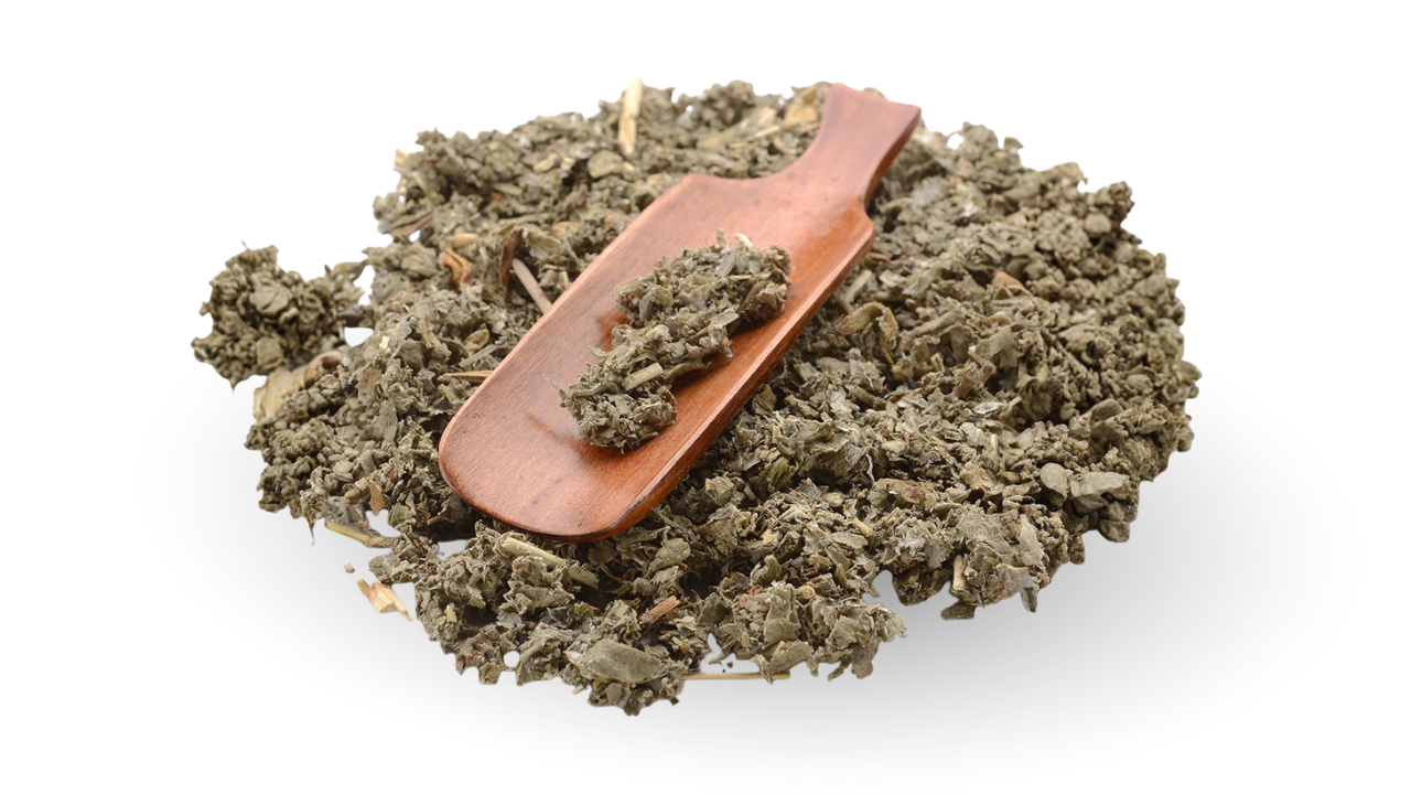 A wooden scoop on a pile of dried organic raspberry leaves, showing the natural green color and herbal texture