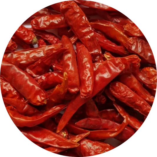 Whole dried organic red chili pods showing naturally wrinkled skin and a deep red color