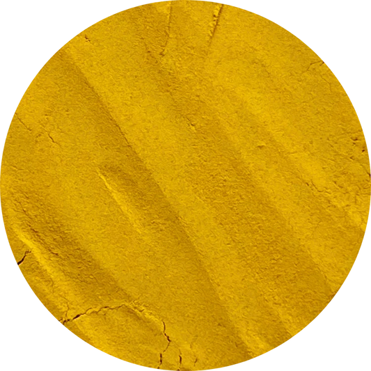 A round mound of organic turmeric powder showing its deep yellow pigment and high curcumin content