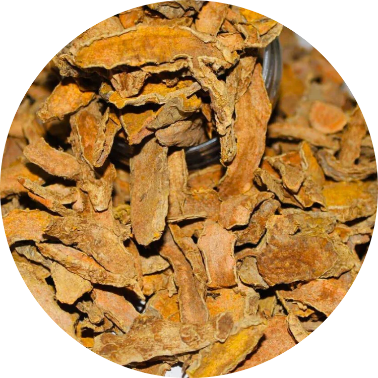 Close-up of dried organic turmeric slices with an orange-brown color