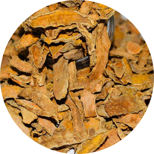 Close-up of dried organic turmeric slices with an orange-brown color